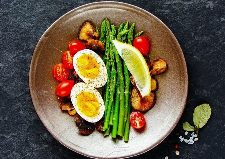 A healthy plate of soft-boiled eggs and asparagus, designed as a balanced meal to provide sustained fuel for those struggling with low energy.