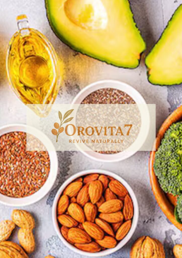 A bright, high-angle shot focusing on plant-based healthy fats. Bowls of almonds, flax seeds, and chia seeds are arranged with olive oil and sliced avocado. The OroVita7 logo is featured prominently in the center of the image.