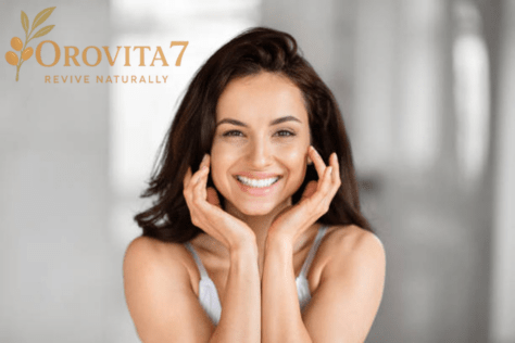 A woman with a bright, radiant smile touching her healthy skin, showcasing the natural revival effects of OroVita7 products.