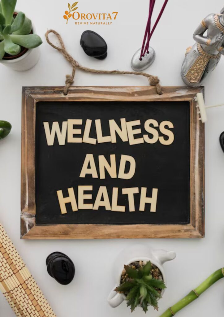 A rustic chalkboard with the words "WELLNESS AND HEALTH" surrounded by zen lifestyle items like succulents, incense, and smooth black stones.