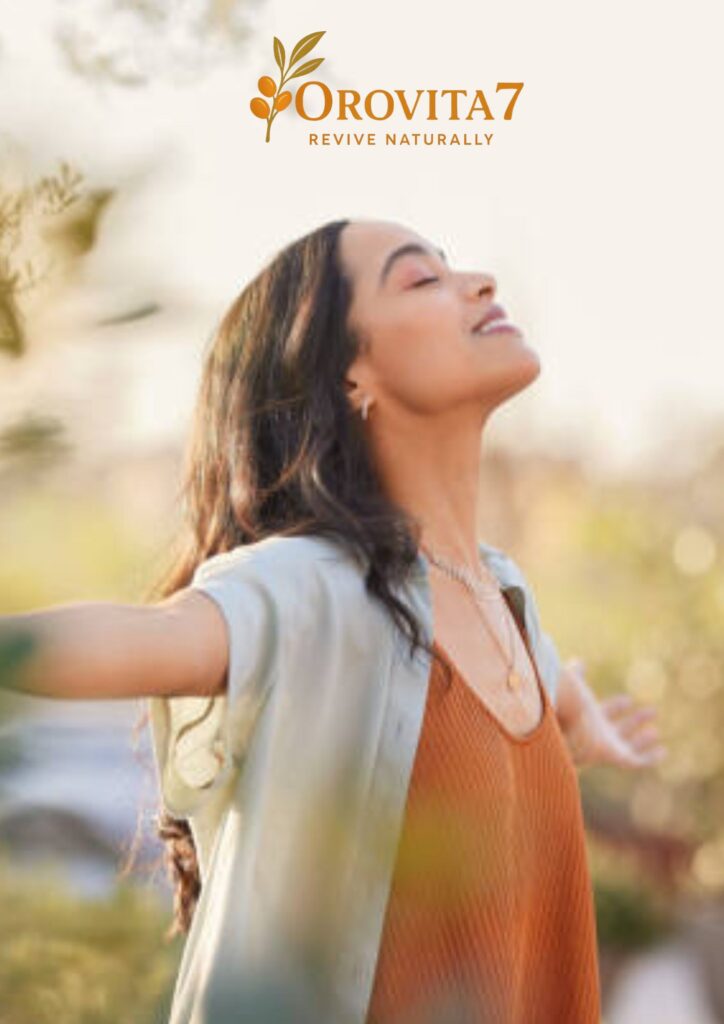 A woman with her eyes closed and arms outstretched in a sunny outdoor setting, representing the natural wellness and revival mission of OroVita7.