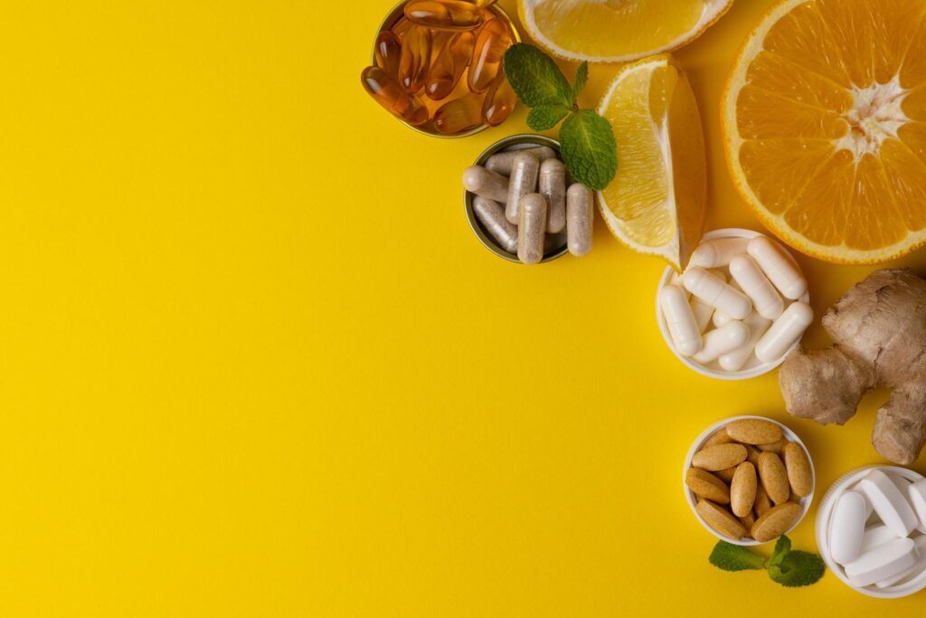 Natural Vitamins concept with oranges, berries, and leafy green vegetables