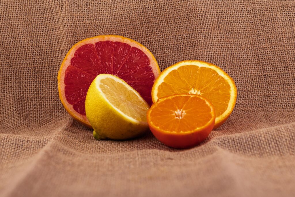 Vitamin C Supplement capsules and powder with fresh fruits for daily wellness